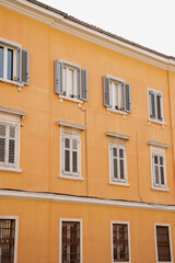 Obraz premium Facade of a Yellow Building with Shutters