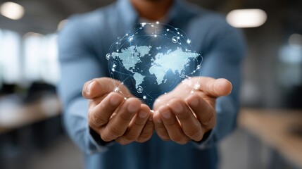 Fototapeta premium Man holds a digital globe with network connections in hands, representing global communication and technology in a modern office environment
