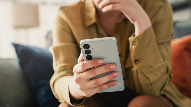 Woman using mobile phone in the living room