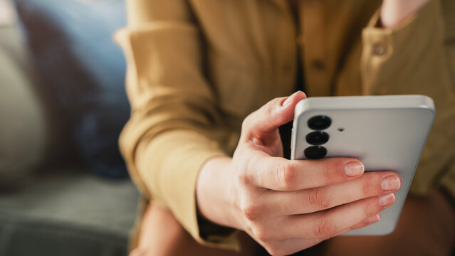 Woman using mobile phone in the living room