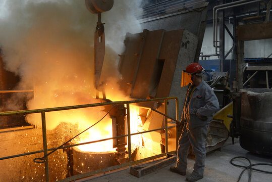 Workers at a melting furnace in an iron foundry