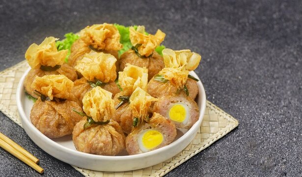 ekkado or ekado, a savory appetizer made with seasoned minced chicken wrapped in tofu skin and topped with a quail egg