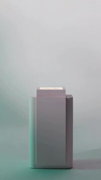 Vertical video: Pulling camera revealing square-capped pack on studio table, for product shot