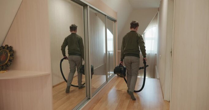 Caucasian Boy Kid Vacuum Hallway Corridor in House. 4K 10-bit