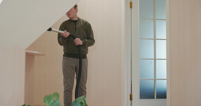 Caucasian Boy Kid Vacuum Hallway Corridor in House. 4K 10-bit