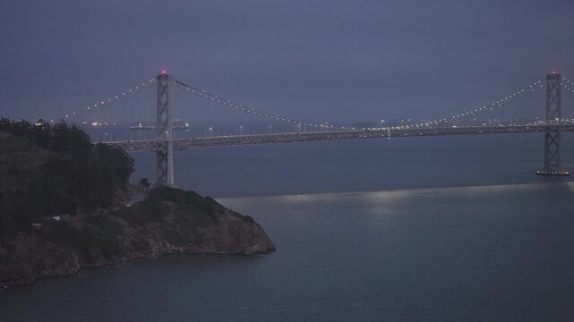 San Francisco Bay Bridge Twin Suspension Towers Lit at Dusk - Cinematic Aerial Shot