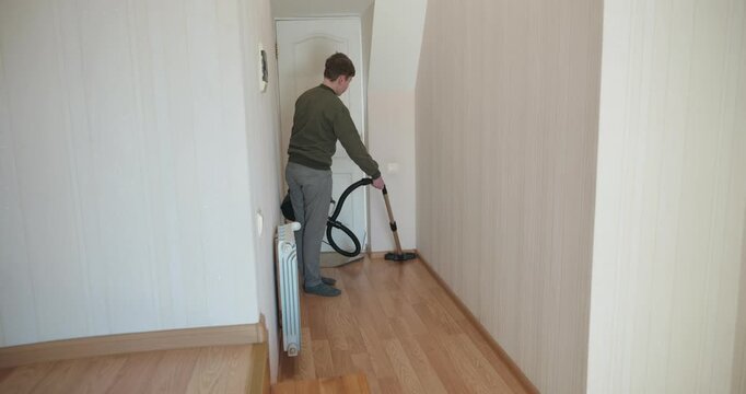Caucasian Boy Kid Vacuum Hallway Corridor in House. 4K 10-bit