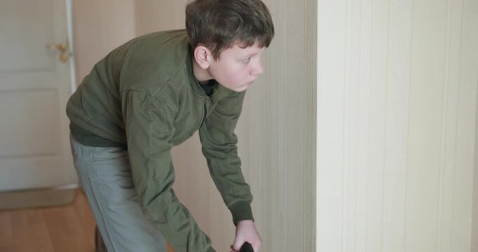 Caucasian Boy Kid Vacuum Hallway Corridor in House. 4K 10-bit