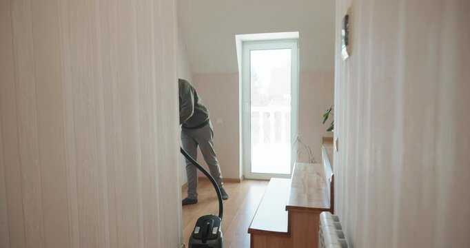 Caucasian Boy Kid Vacuum Hallway Corridor in House. 4K 10-bit