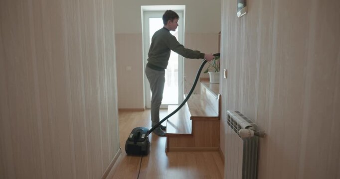Caucasian Boy Kid Vacuum Hallway Corridor in House. 4K 10-bit