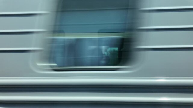 A blurred image of a train passing a moving train