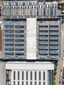 Aerial view of a data centre roof featuring rows of cooling units and technical infrastructure in London, England, United Kingdom.