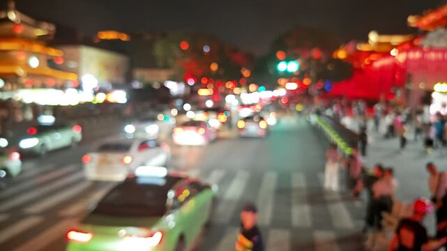 A vibrant and bustling urban intersection in modern China illuminated by various lights from vehicles