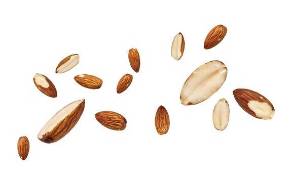 Scattered raw almonds and split almond halves floating against a plain white background