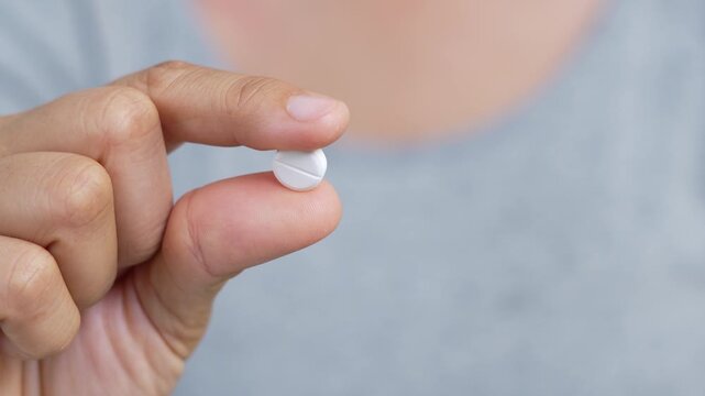 close up woman hand holding a medicine. Stop drug use Taking Medication Caring for the health care medical concept.