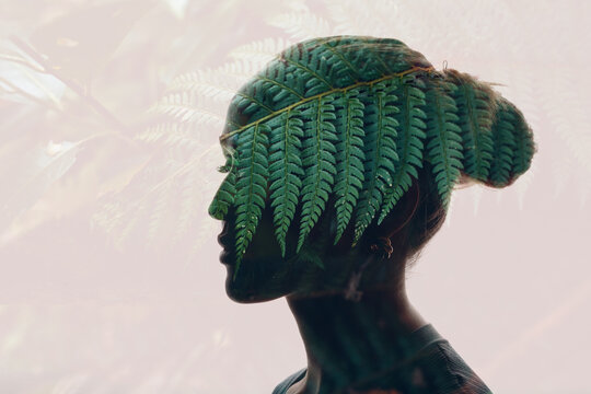 Silhouette portrait of a young woman with a forest and green plants inside. Eco friendly and ecology concept. Double exposure.