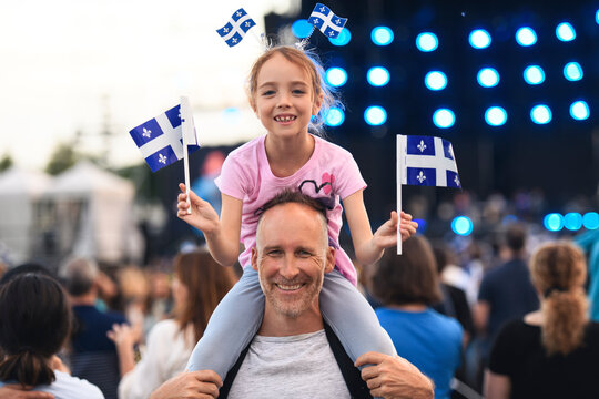 Father and daughter on national quebec day. The child is on the shoulder.