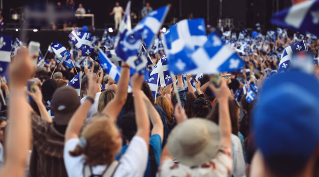 Quebec national birthday crowd holding lot of quebec flag