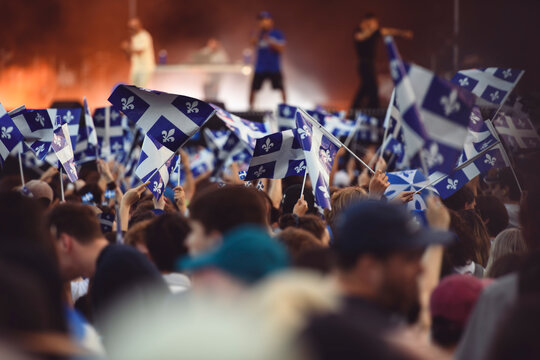 Quebec national birthday crowd holding lot of quebec flag