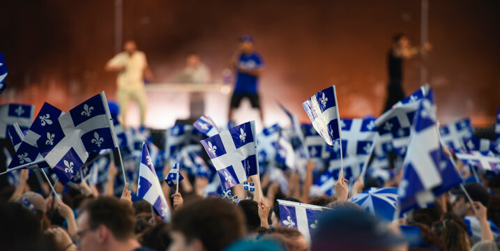 Quebec national birthday crowd holding lot of quebec flag