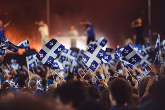 Quebec national birthday crowd holding lot of quebec flag