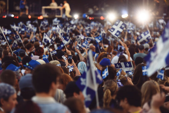 Quebec national birthday crowd holding lot of quebec flag