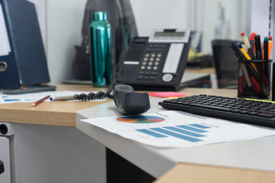 Office desk workspace with business reports and technology