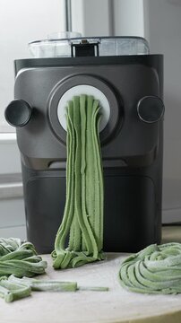 Green spinach pasta dough transformed into fresh homemade tagliatelle