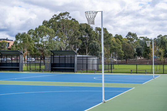 Netball ring and post at an outdoor court and parkland in suburban Melbourne, Australia. Community sports equipment. Concept of recreation amenity, and local sport facility