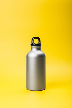Silver Reusable Bottle on Yellow Background