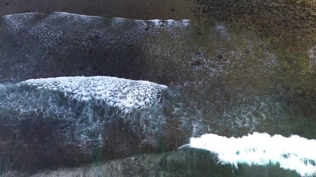 Top Down Aerial Drone View of Ocean Waves Crashing on Sandy Beach