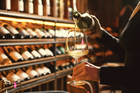 Elegant White Wine Pour by Sommelier
