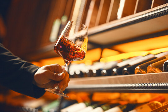 Swirling Red Wine in Elegant Cellar