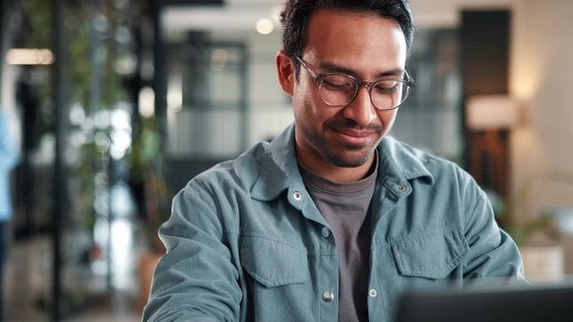 Smile, man and laptop with reading in office for publication revision, blog approval or fact check. Creative, editor and happy with tech at media agency for story angle, proofreading and newsletter
