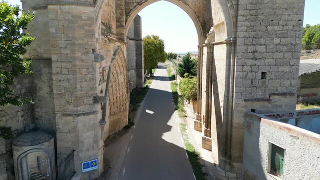 A Grand stone arch of San Anton rising over the Camino de Santiago road in Spain