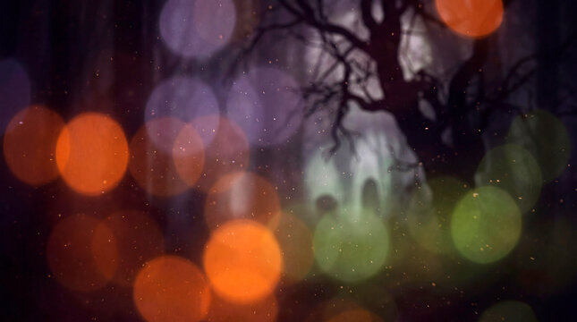 Dreamy Halloween bokeh lights with ghostly silhouette in dark misty autumn forest