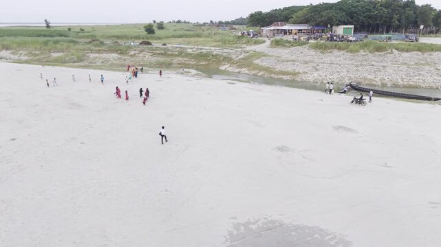 KUSHTIA, BANGLADESH &ndash; JUNE 27, 2026: Drone footage of people exploring the sandy shoreline at the Gorai Confluence in Kushtia, Bangladesh.