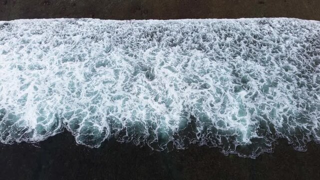 Top Down Aerial Drone View of Ocean Waves Crashing on Sandy Beach