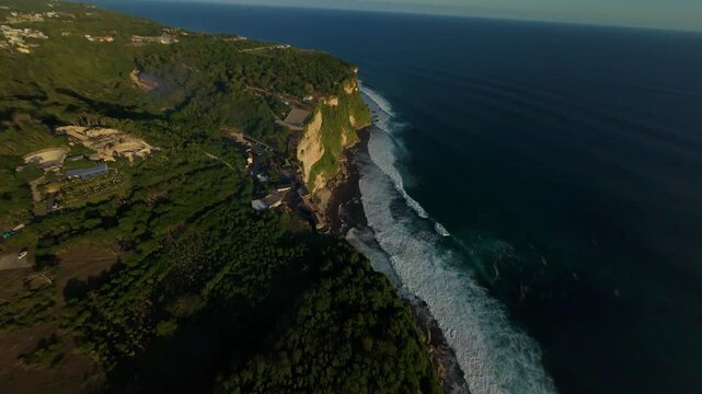 Aggressive FPV Drone Dive Along Karang Boma Cliff Above Ocean Breakers, Dynamic First Person Perspective Over Rugged Coastline, Courage And Adventure