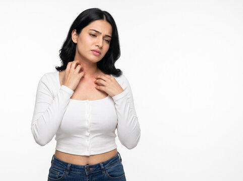 Young fair skinned Indian woman suffering from severe neck itching and skin irritation isolated on white background for healthcare advertising