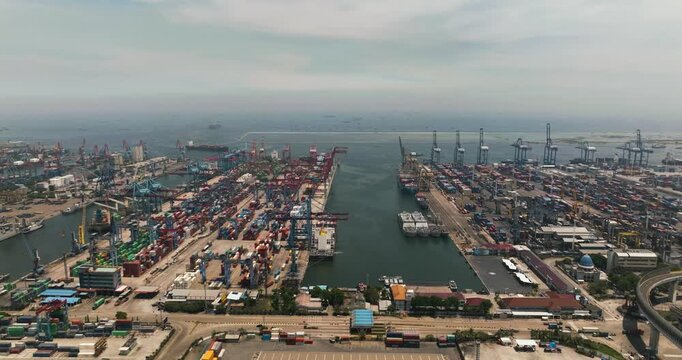 Aerial drone ofsea cargo port with containers and cranes. Tanjung Priok port. Indonesia.