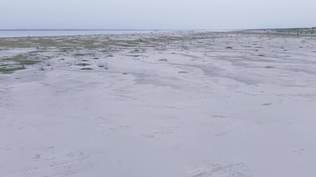 Smooth forward drone reveal over the Padma River char in Kushtia, Bangladesh. High-quality 4K aerial footage showcasing seasonal sand formations, river shoreline, and the natural beauty of Bangladesh.