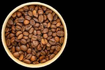 Fototapeta premium Roasted coffee beans isolated on black background. Top view.