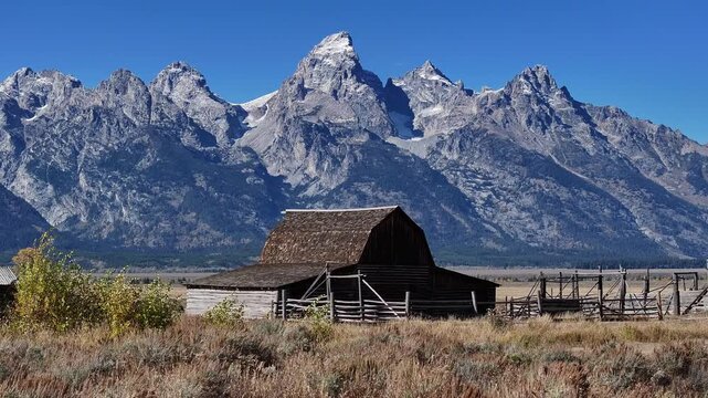 Aerial view of the grassland and wooden houses in Grand Teton National Park, USA, showcasing the natural scenery.
