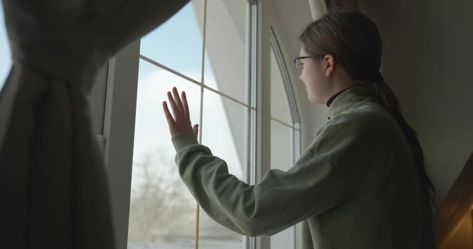 Thoughtful Girl Stand Near Window and Look Outside. 4K 10-bit