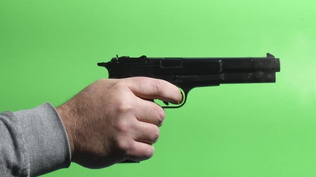 Chromakey - Gunshot close up on green screen with hand movement and action