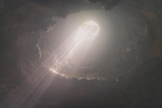 Jomblang cave in Gunungkidul is a doline formed by a cave collapse a large, natural sinkhole with steep edges surrounded by trees. Geological formations and natural land changes