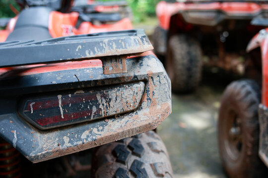 Close up muddy all terrain vehicle off road tire outdoor adventure transportation red rugged dirt vehicle travel recreation nature equipment wheel sport powerful machine