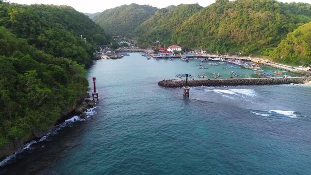 Aerial Drone View of Traditional Fishing Boats Moored at Sadeng Fishing Port During Sunset, Yogyakarta, Indonesia