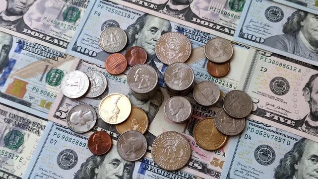 Paper US dollar bills of various denominations and cent coins as a business tool for exchange and trade. Cash US dollars as a background for your design